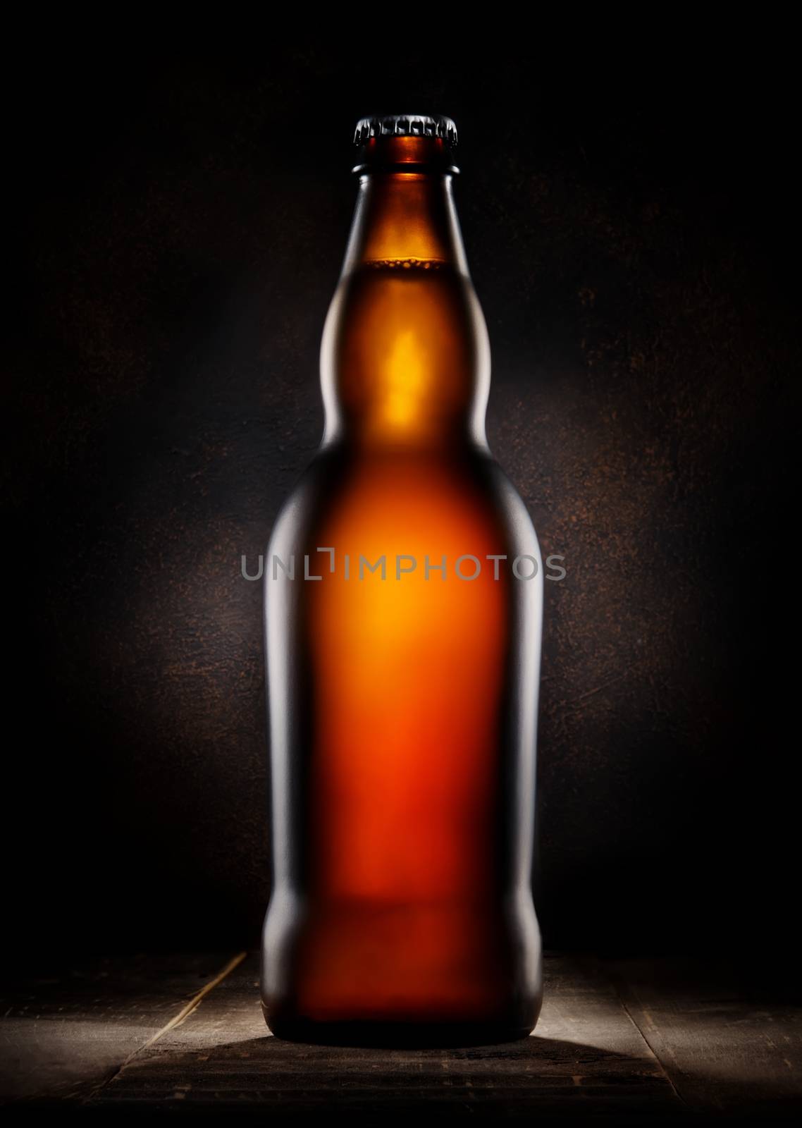 Lager beer in bottle on wooden background