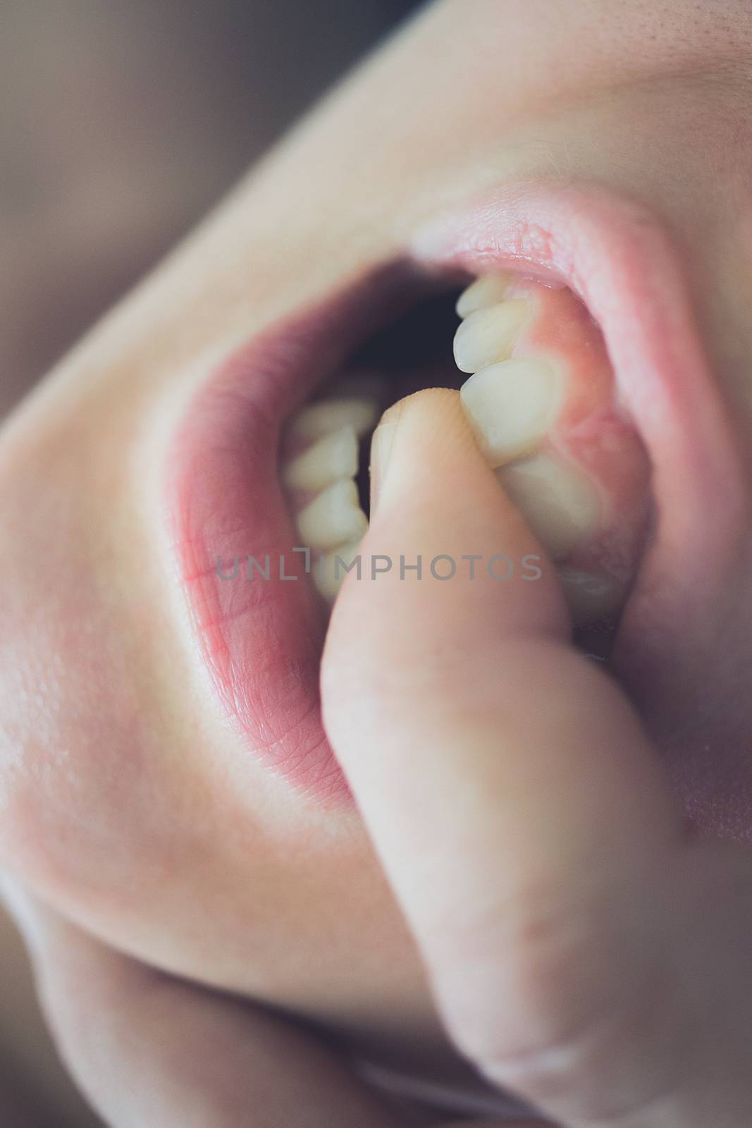 Pretty young woman enjoying with boyfriend, his finger in her mouth