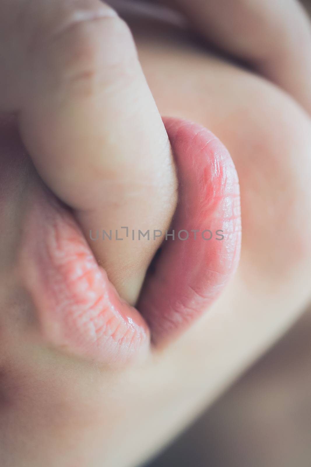 Pretty young woman enjoying with boyfriend, his finger in her mouth