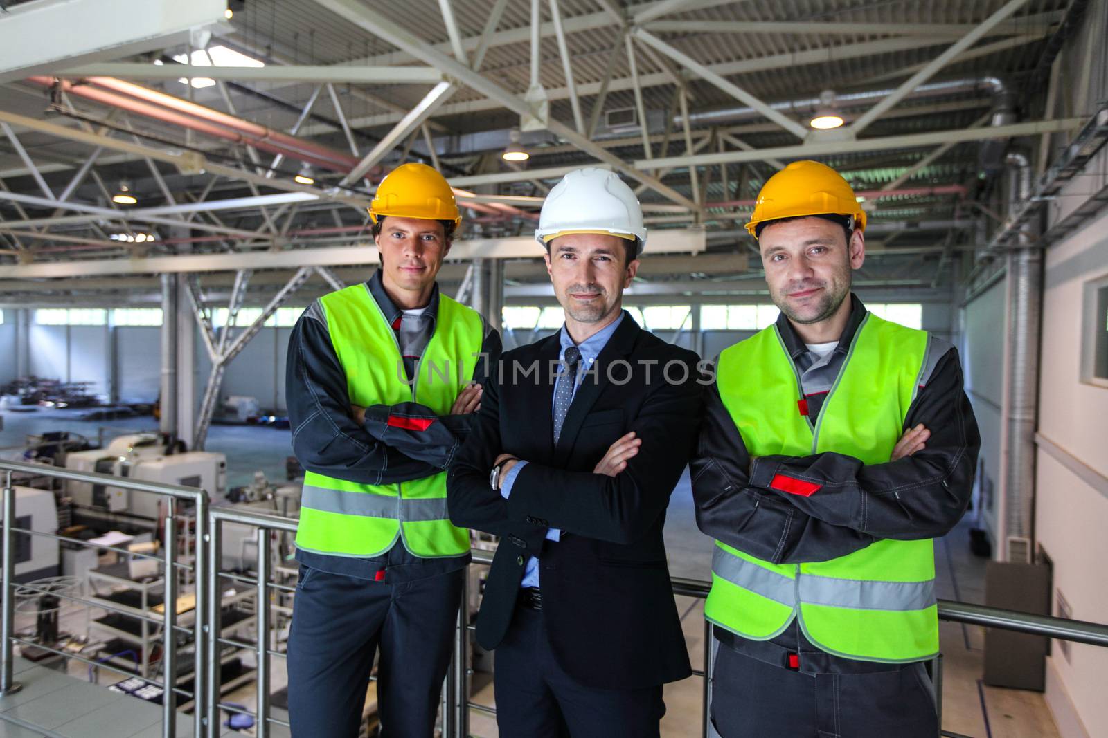 Team of manager and two workers in CNC factory
