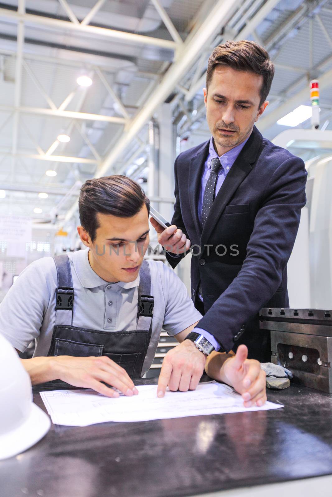 Men working with documents at plant by ALotOfPeople