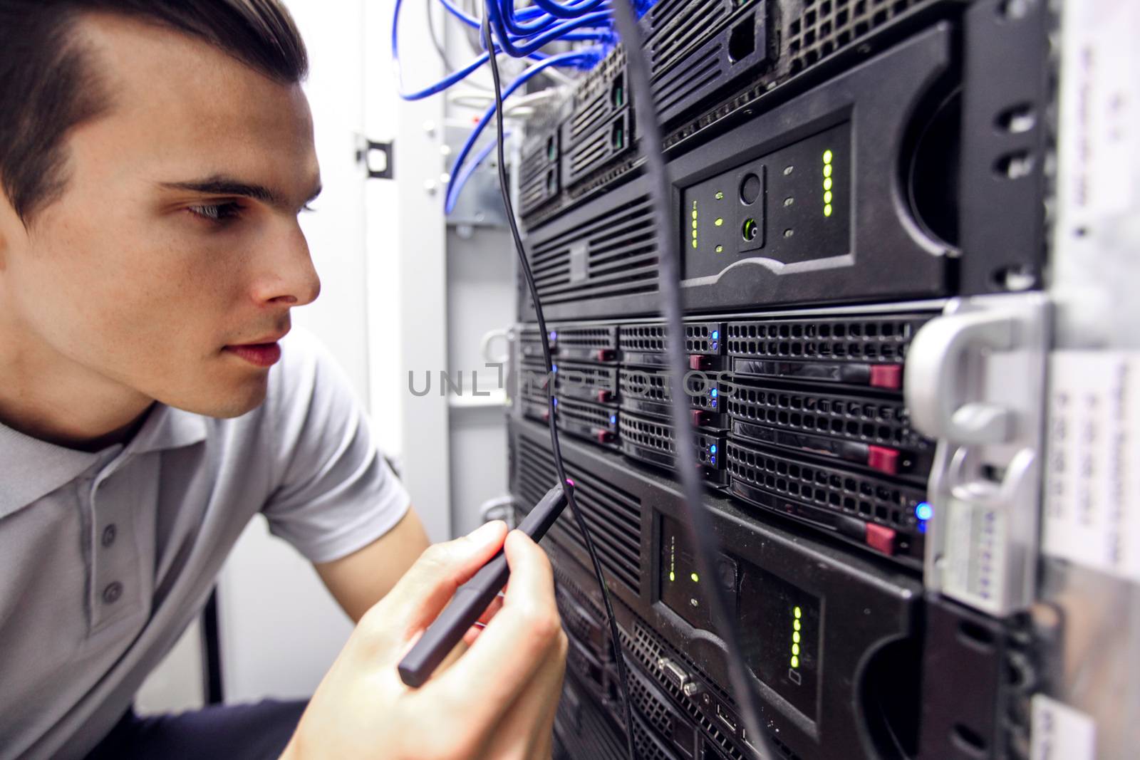 Engeneer in network server room by ALotOfPeople