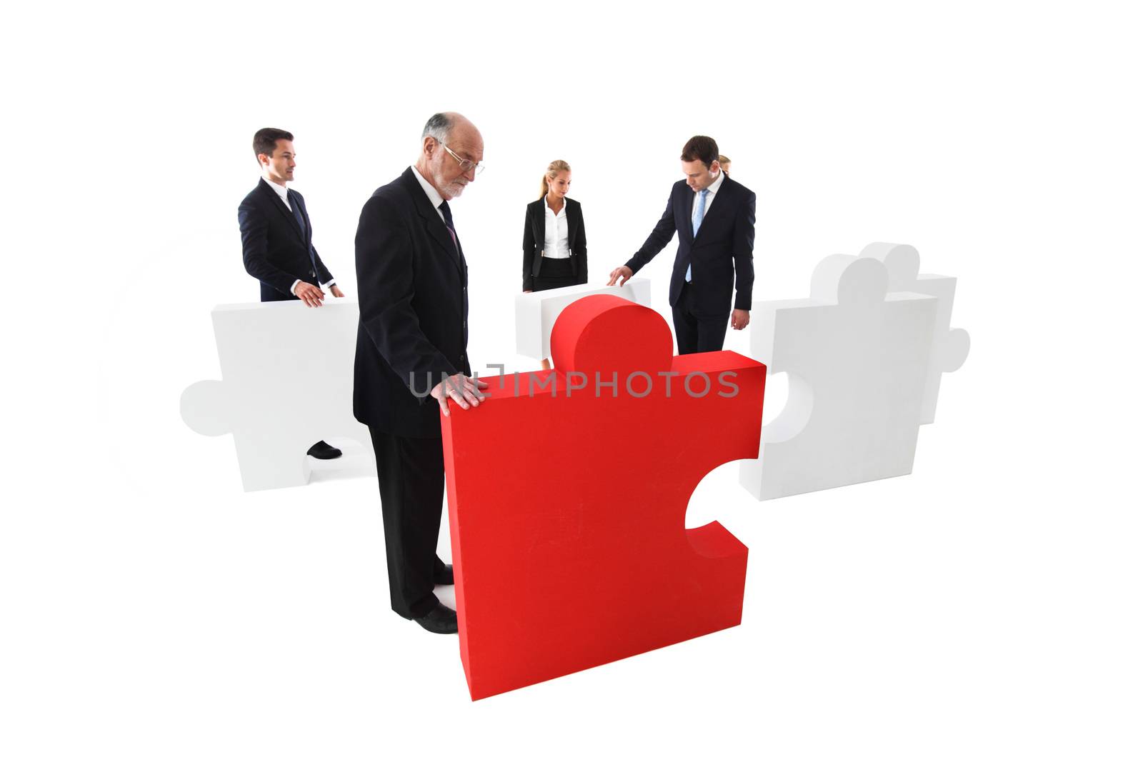 Business team assembling big puzzle isolated on white background