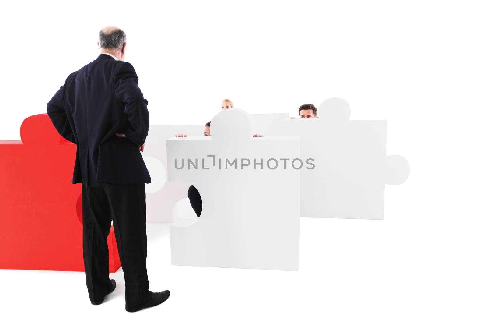 Angry businessman threatens colleague responsible for laziness, staff afraid hiding behind puzzle