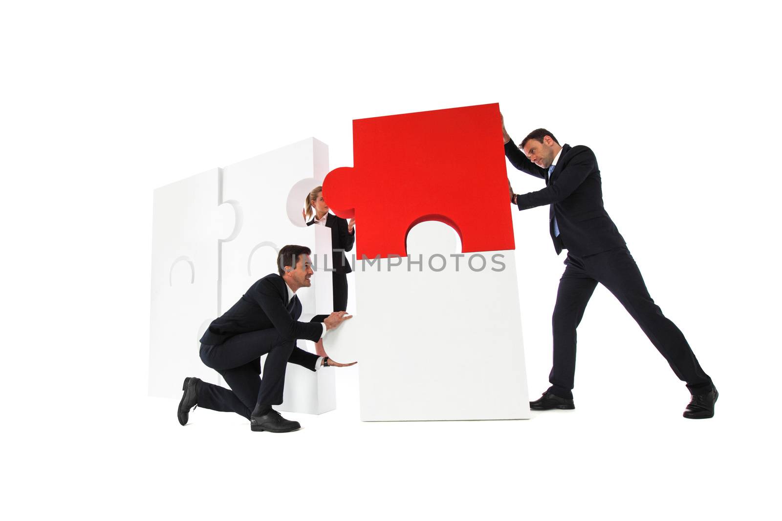 Business team assembling big puzzle isolated on white background