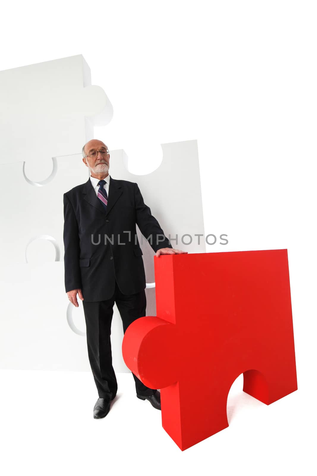 Business man portrait and big puzzle isolated on white background