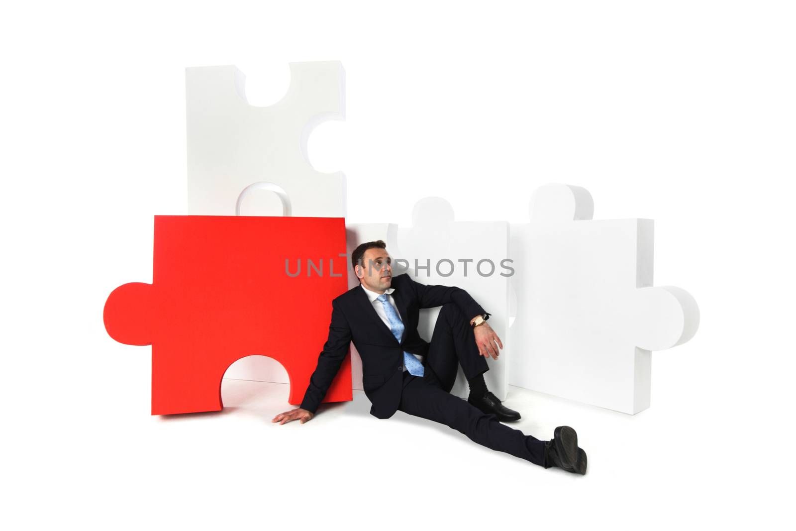 Thinking business man and puzzle isolated on white