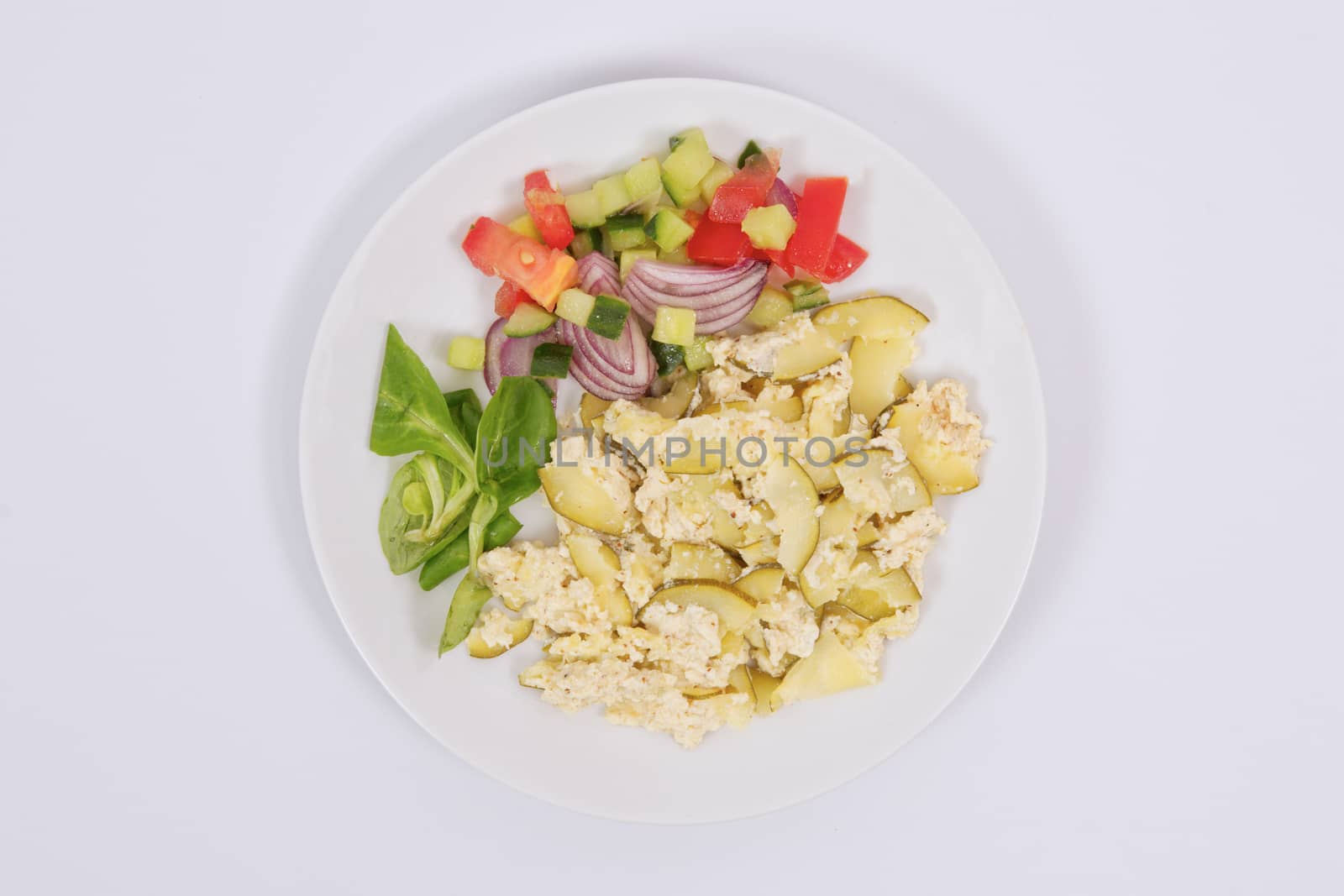 Baked zucchini vegetable salad on a white background