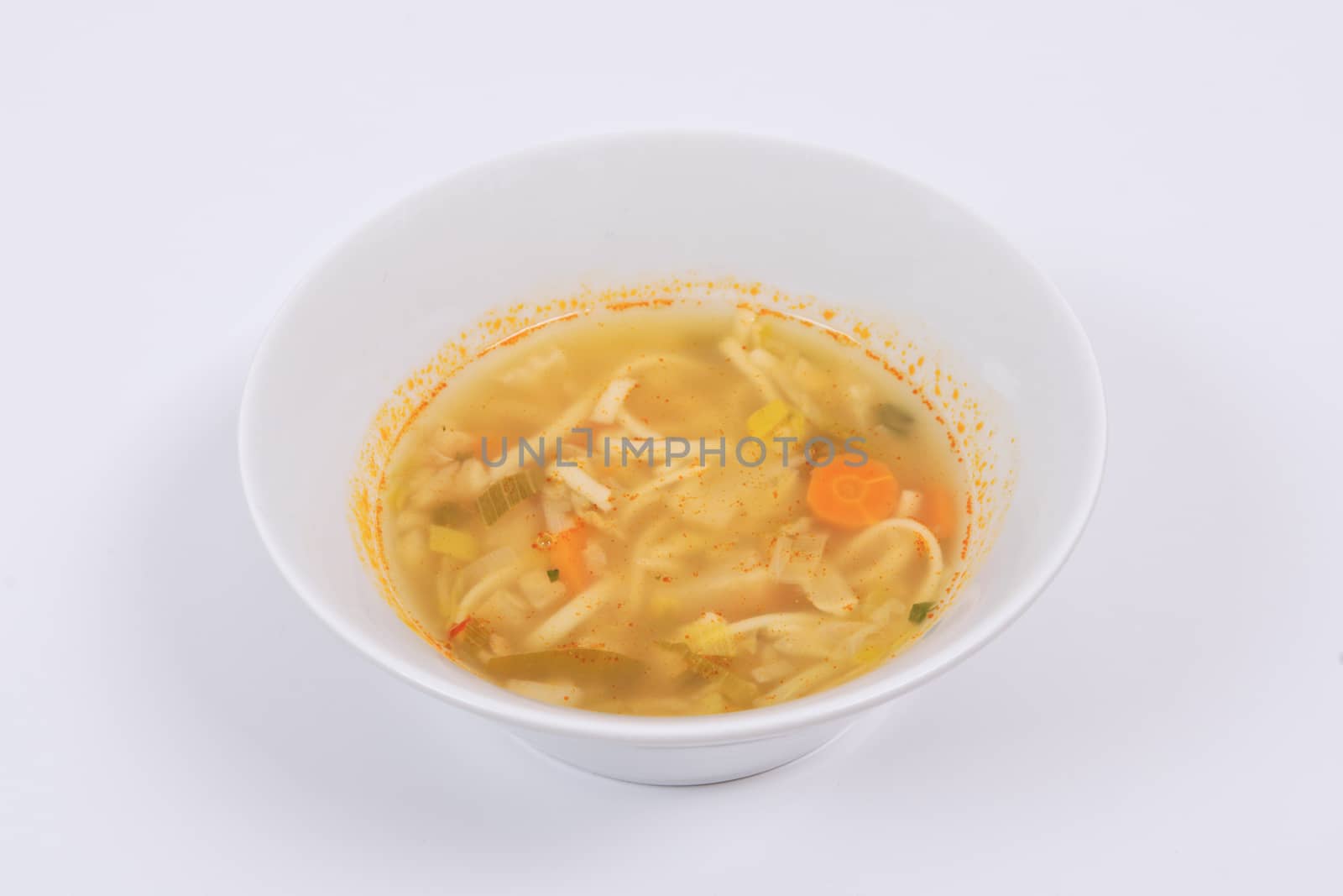 Noodle soup with vegetables on a white background