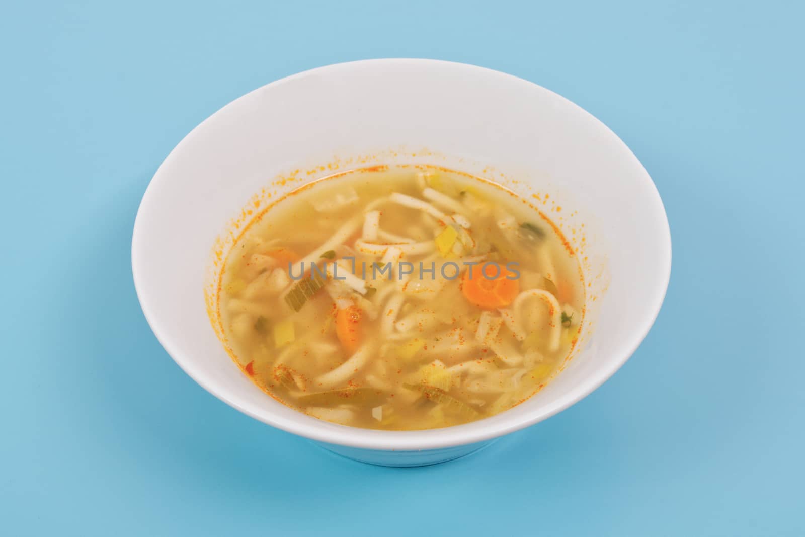 Noodle soup with vegetables on a white background