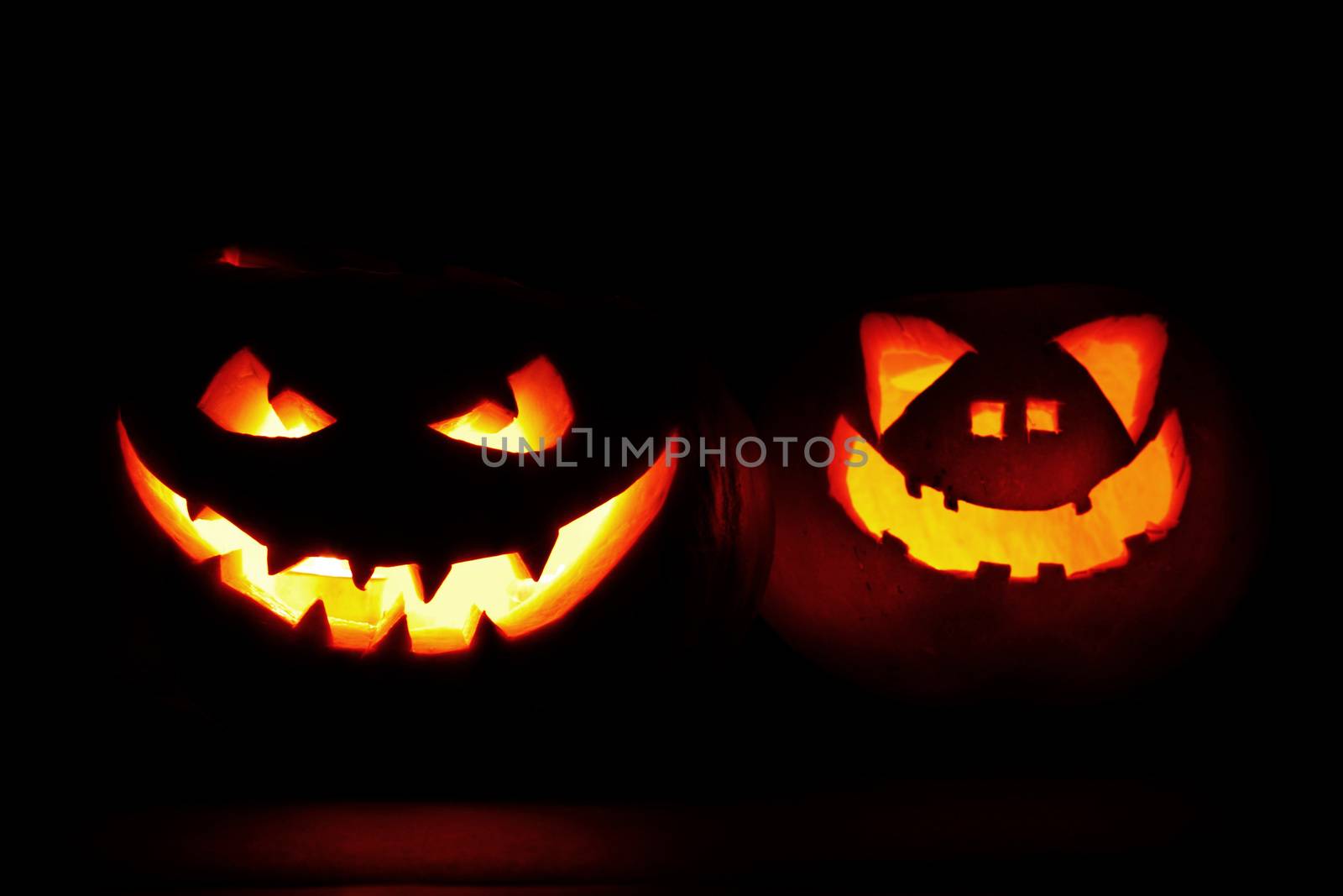 Halloween pumpkin heads jack lantern with scary evil faces on black