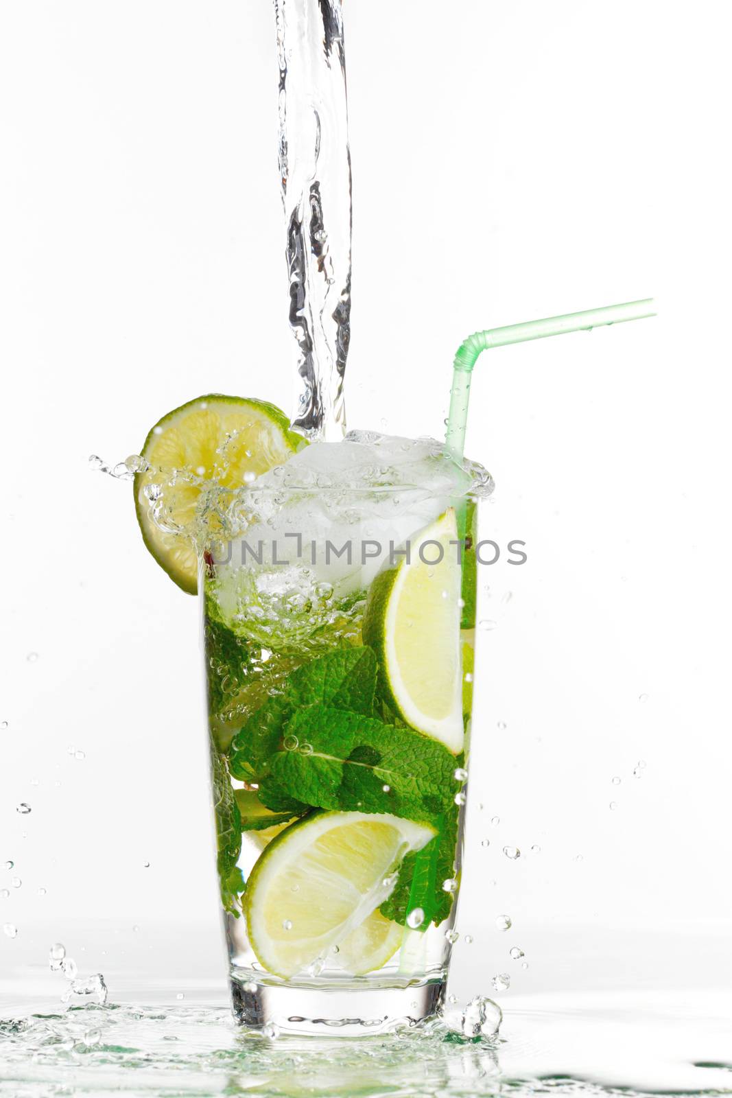 Making mojito cocktail with lime and mint isolated on white background