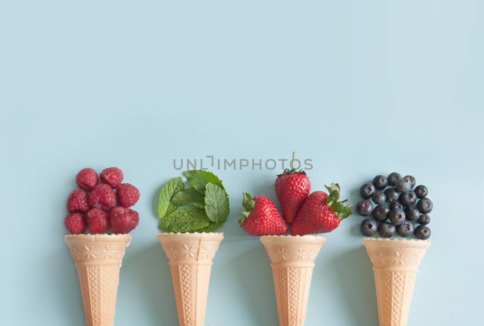 Four icecream cones with natural ingredients including berries, and mint flavors