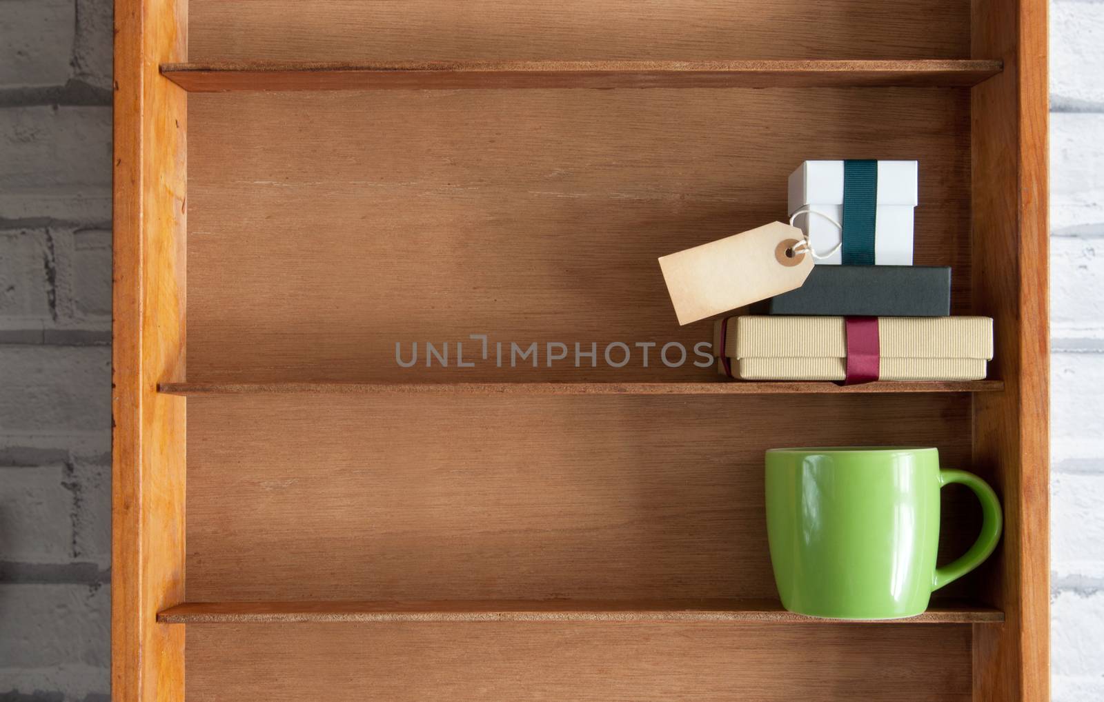 Gifts with blank label inside a shelf unit with coffee cup