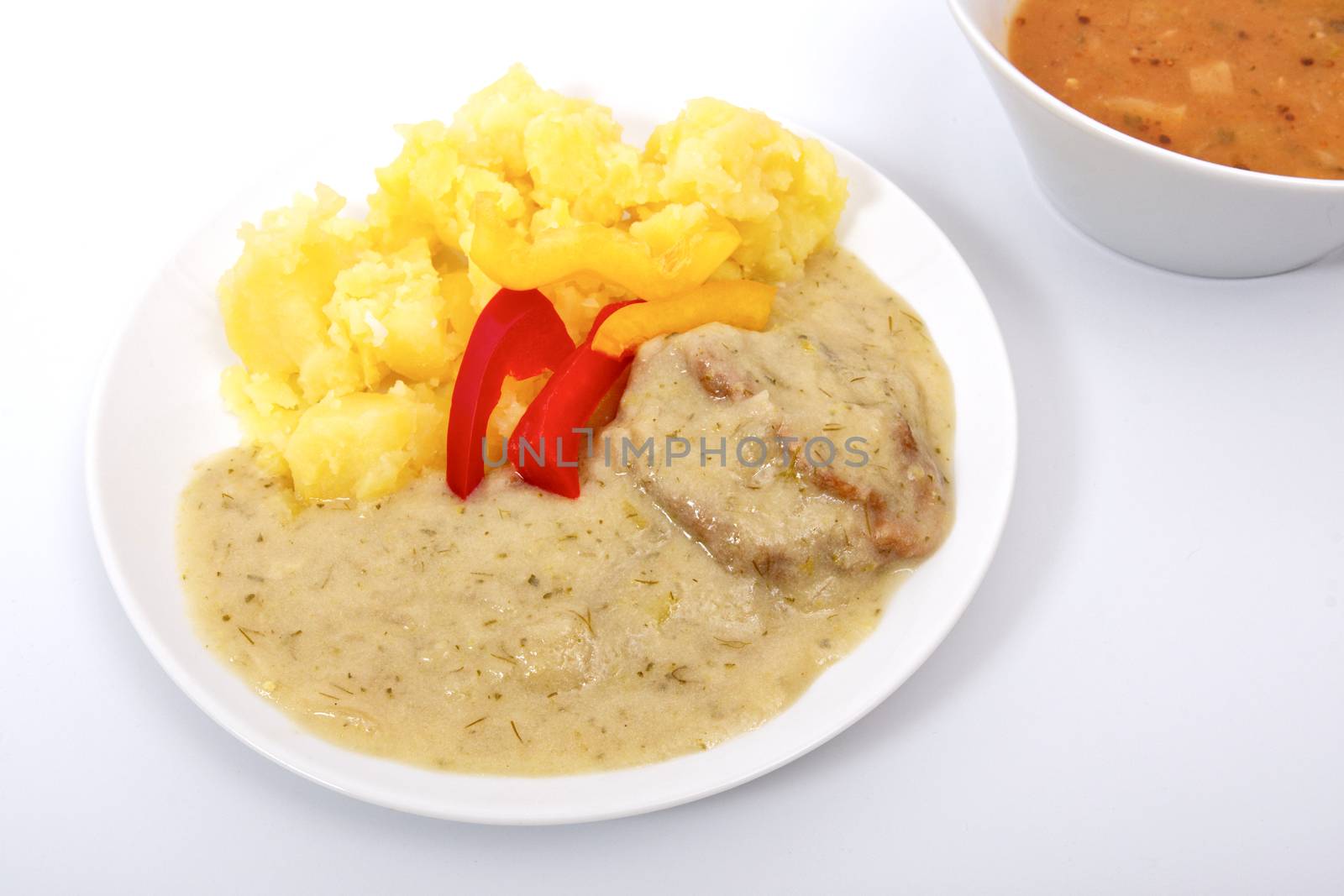 Seitan with dill sauce and potatoes on a white background