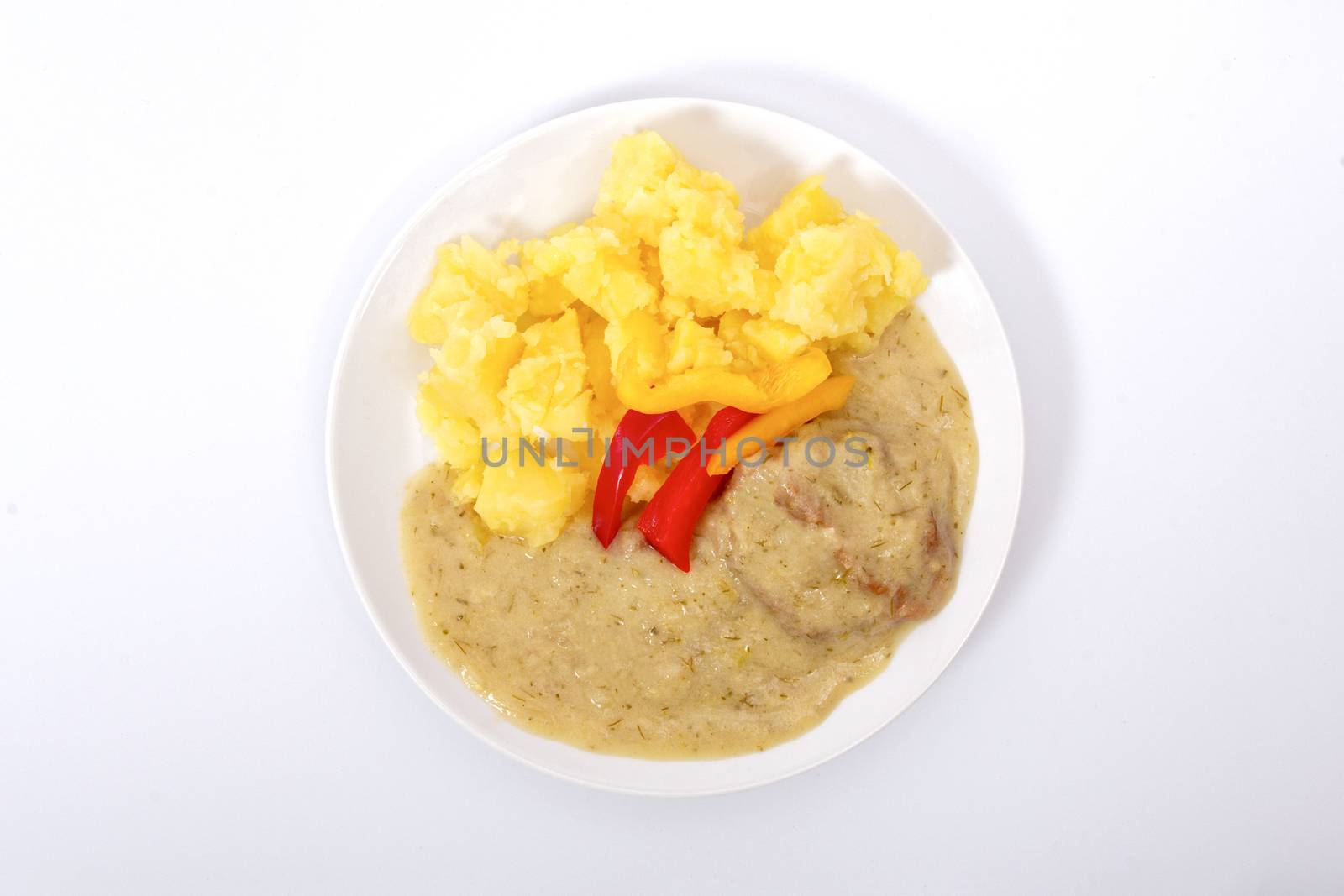 Seitan with dill sauce and potatoes on a white background