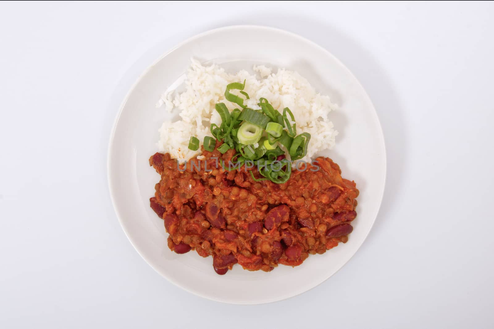 Indian legume hash with rice on a white by neryx