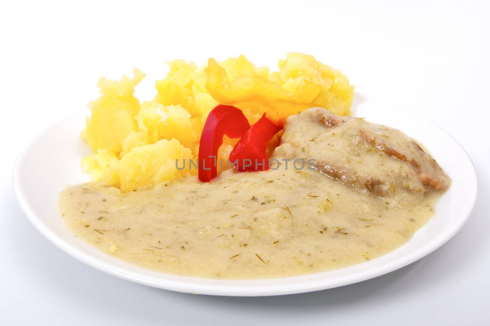 Seitan with dill sauce and potatoes on a white background