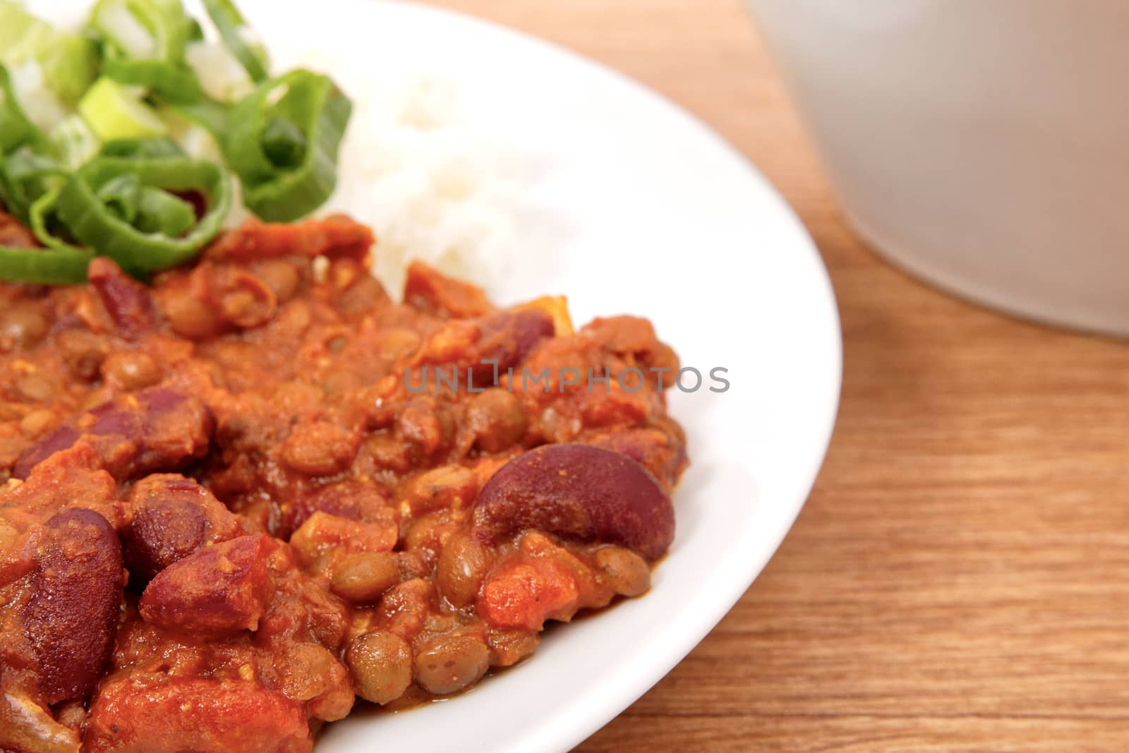 Indian legume hash with rice on a wooden table