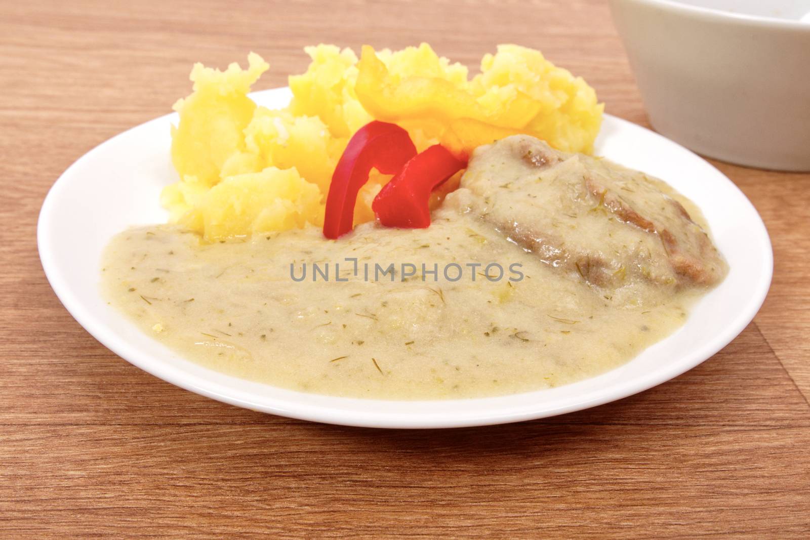 Seitan with dill sauce and potatoes on a table by neryx