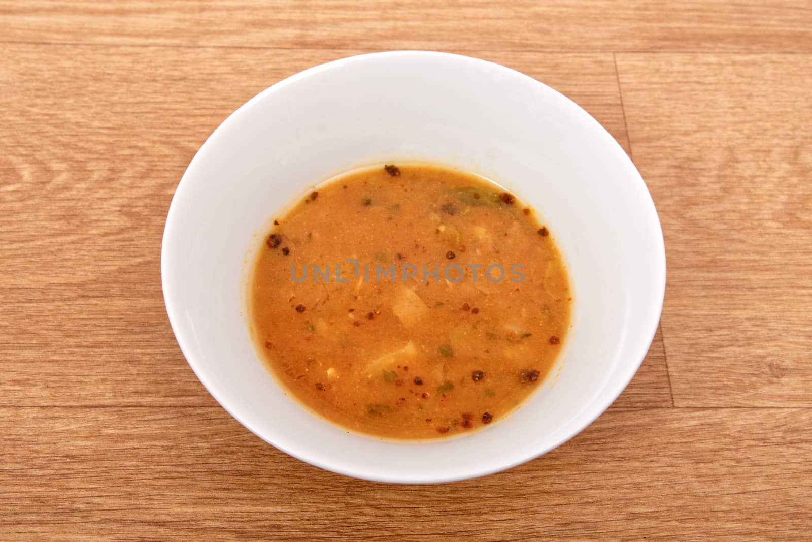 Oyster mushroom soup with vegetables on a wooden table