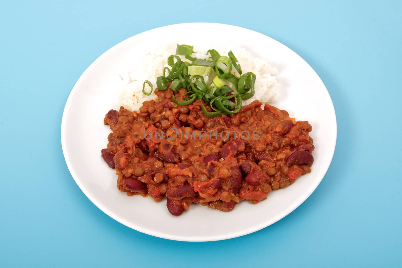 Indian legume hash with rice on a blue background