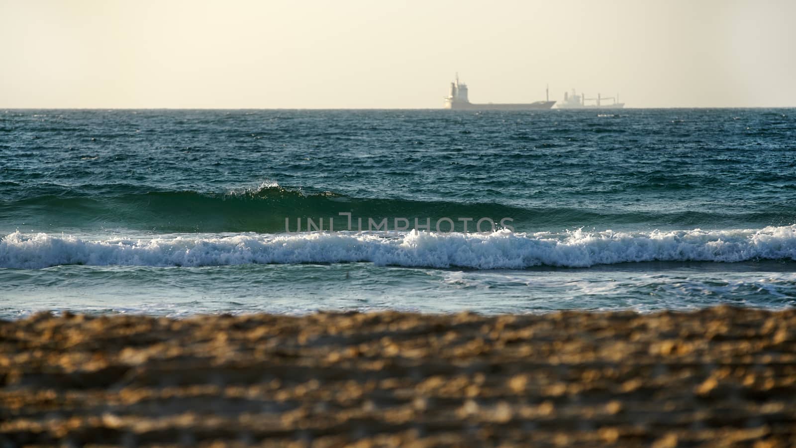 seascape, view from shore to waves and ship