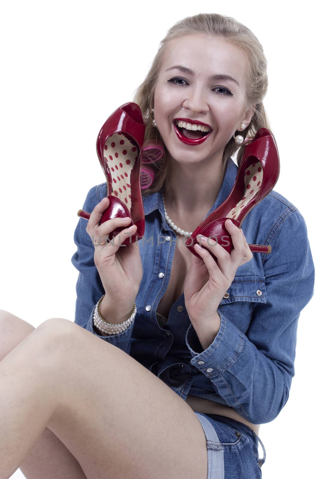 Portrait of a young blonde woman with red shoes