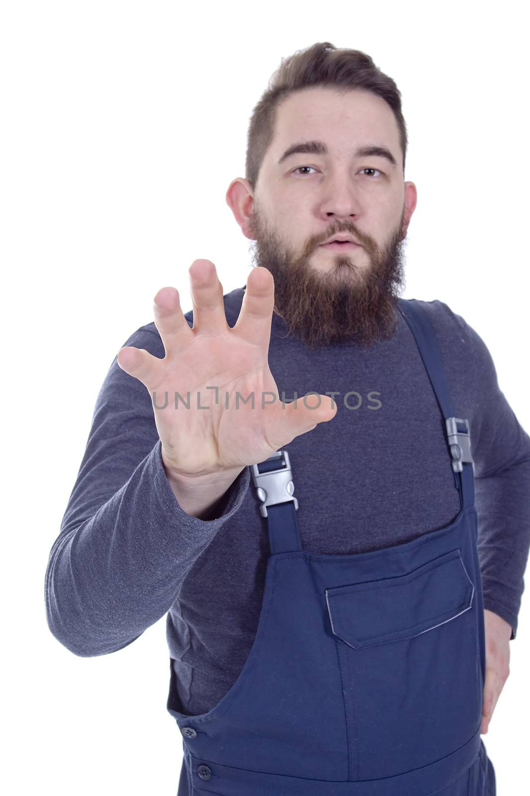 Young bearded man in overalls with a hand doing rotational movements