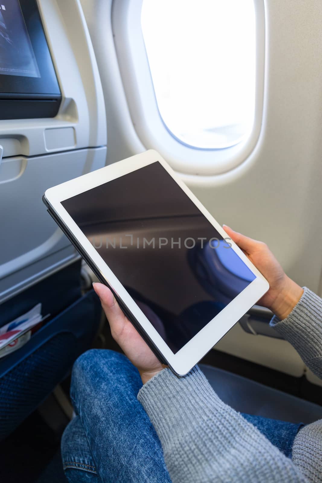Woman use of tablet pc inside aircraft