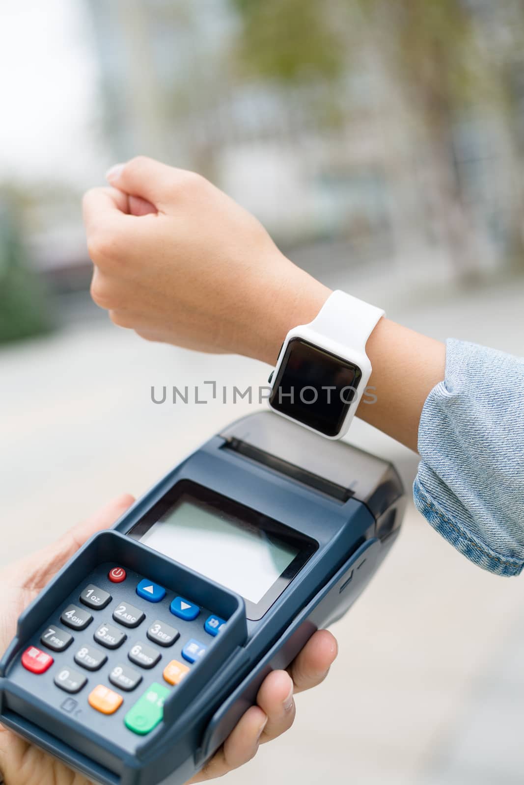 Customer using smart watch to checkout by leungchopan