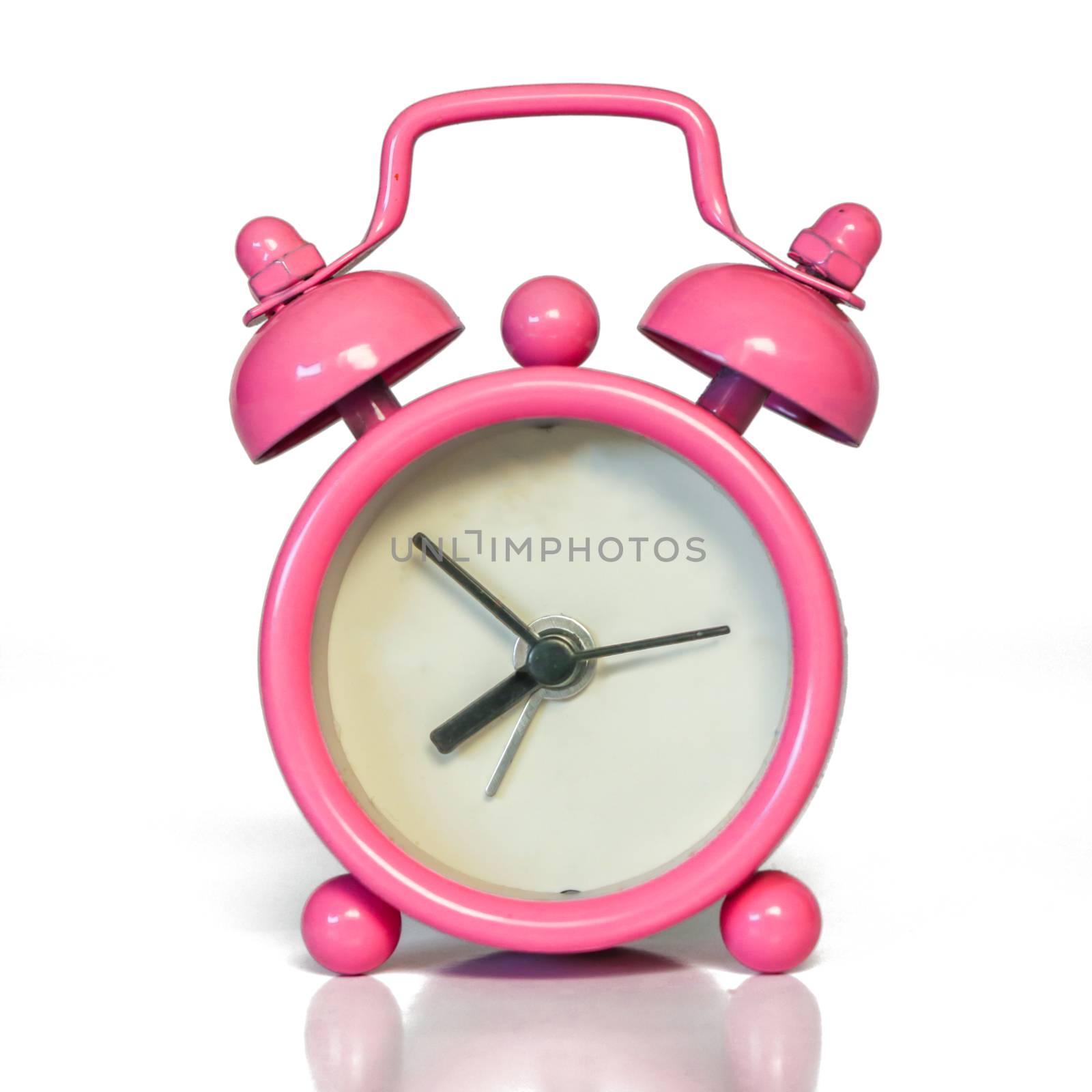 Miniature Vintage Pink Alarm Clock - Minimal Design. Beautiful Pastel Color. Isolated with real shadow reflected on white.