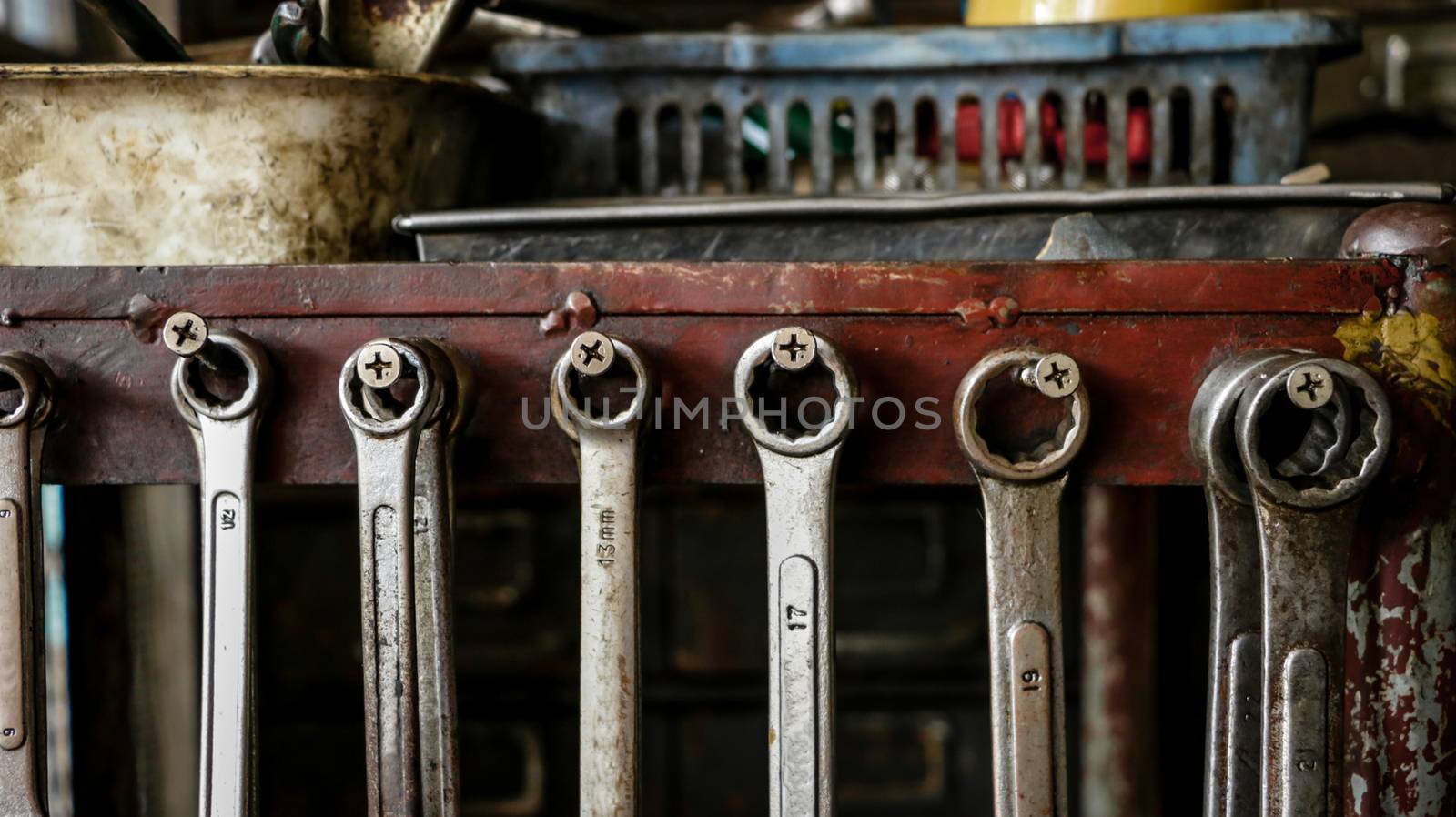 Set of Dirty Wrenches/ Spanners on Wooden Shelf with Different Tools in Garage. Motorbike Repair Shop in  Thailand.