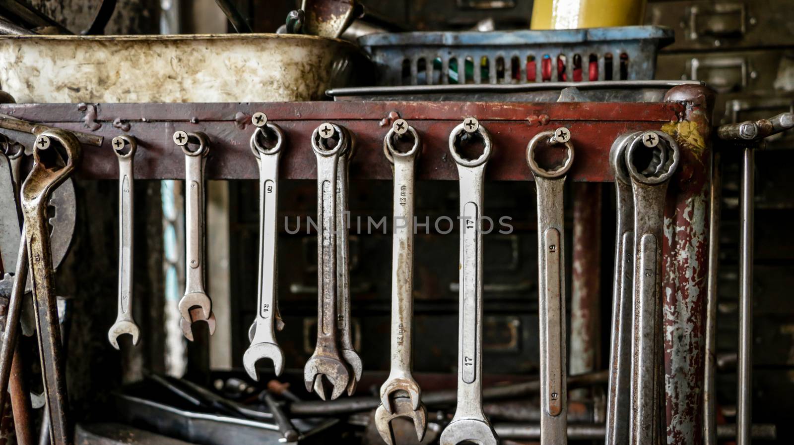 Set of Dirty Wrenches/ Spanners on Wooden Shelf with Different Tools in Garage. Motorbike Repair Shop in  Thailand.