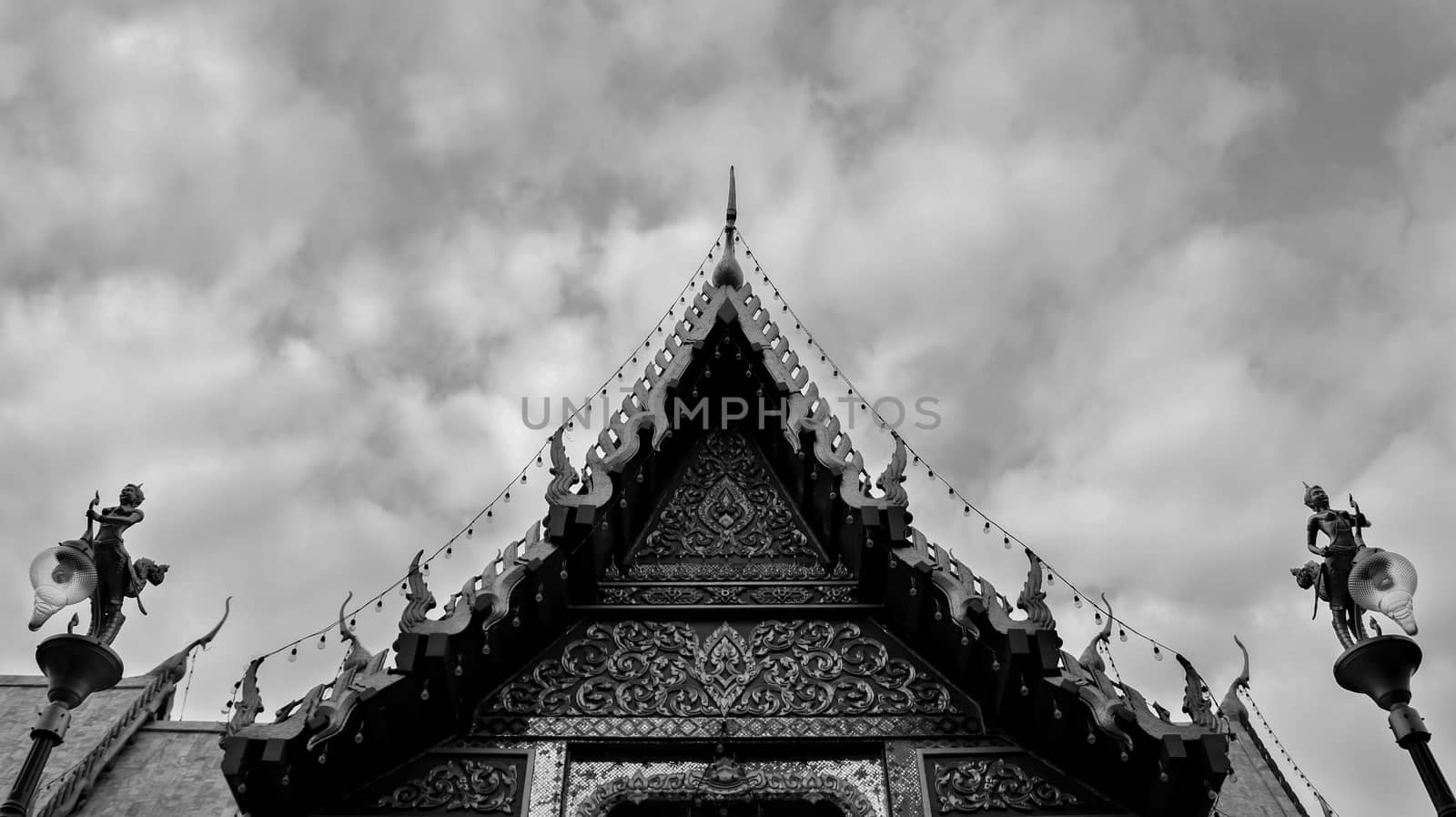 Monochromatic Symmetrical Buddhist Temple Roof in Bangkok Thailand with Beautiful Patterns. Cloudy Sky. High Contrast.