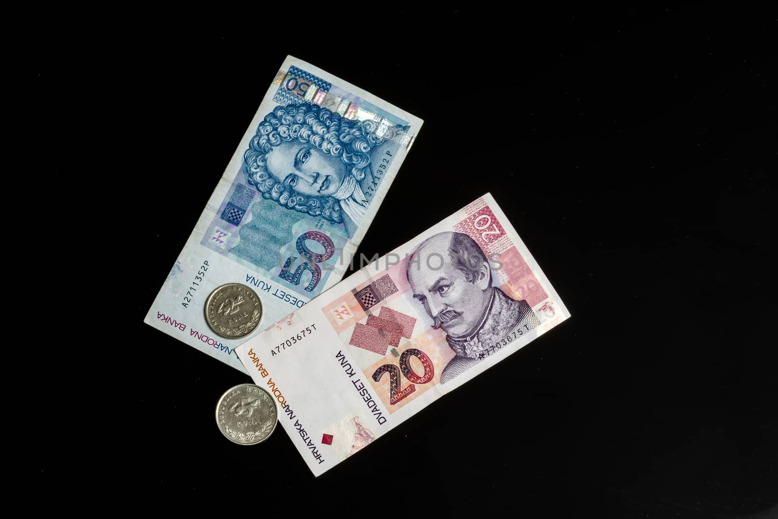Kuna - Croatian currency, coins and paper notes isolated on black