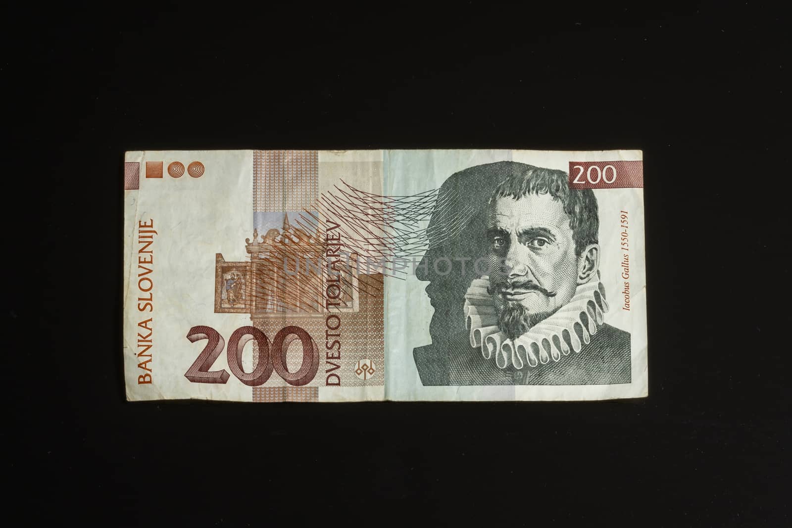 Obsolete 200 tolar bill of Slovenia, became obsolete with introduction of Euro currency, isolated on black background