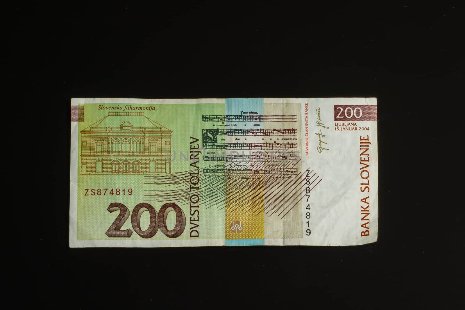 Obsolete 200 tolar bill of Slovenia, became obsolete with introduction of Euro currency, isolated on black background