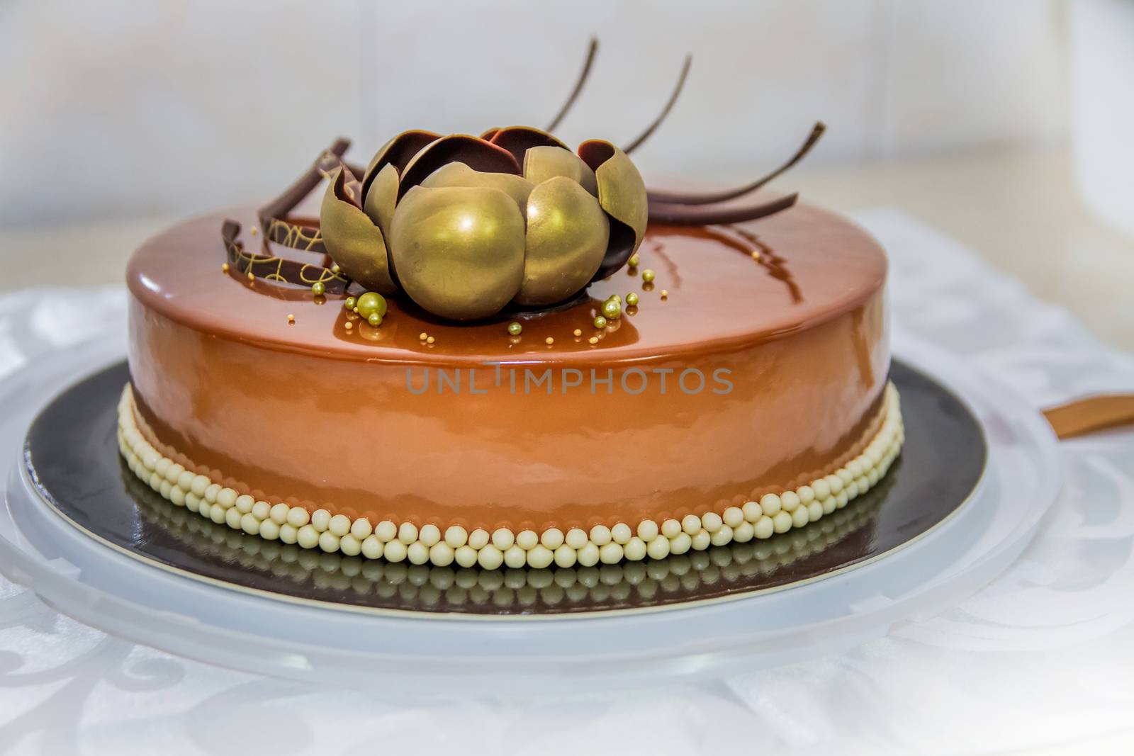 Golden chocolate cake with flower and pearls gatsby party