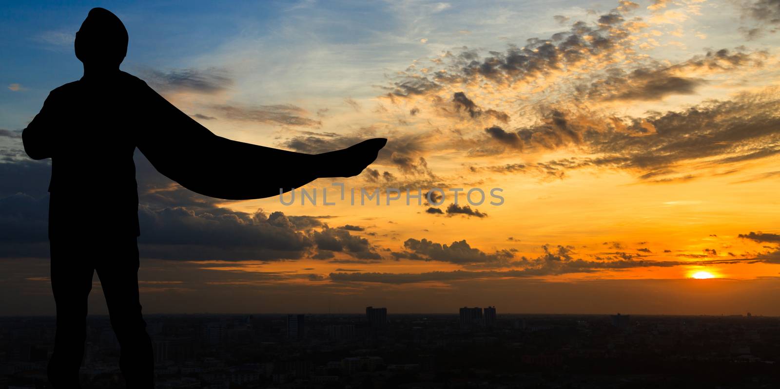 Silhouette of Super businessman at twilight in the city