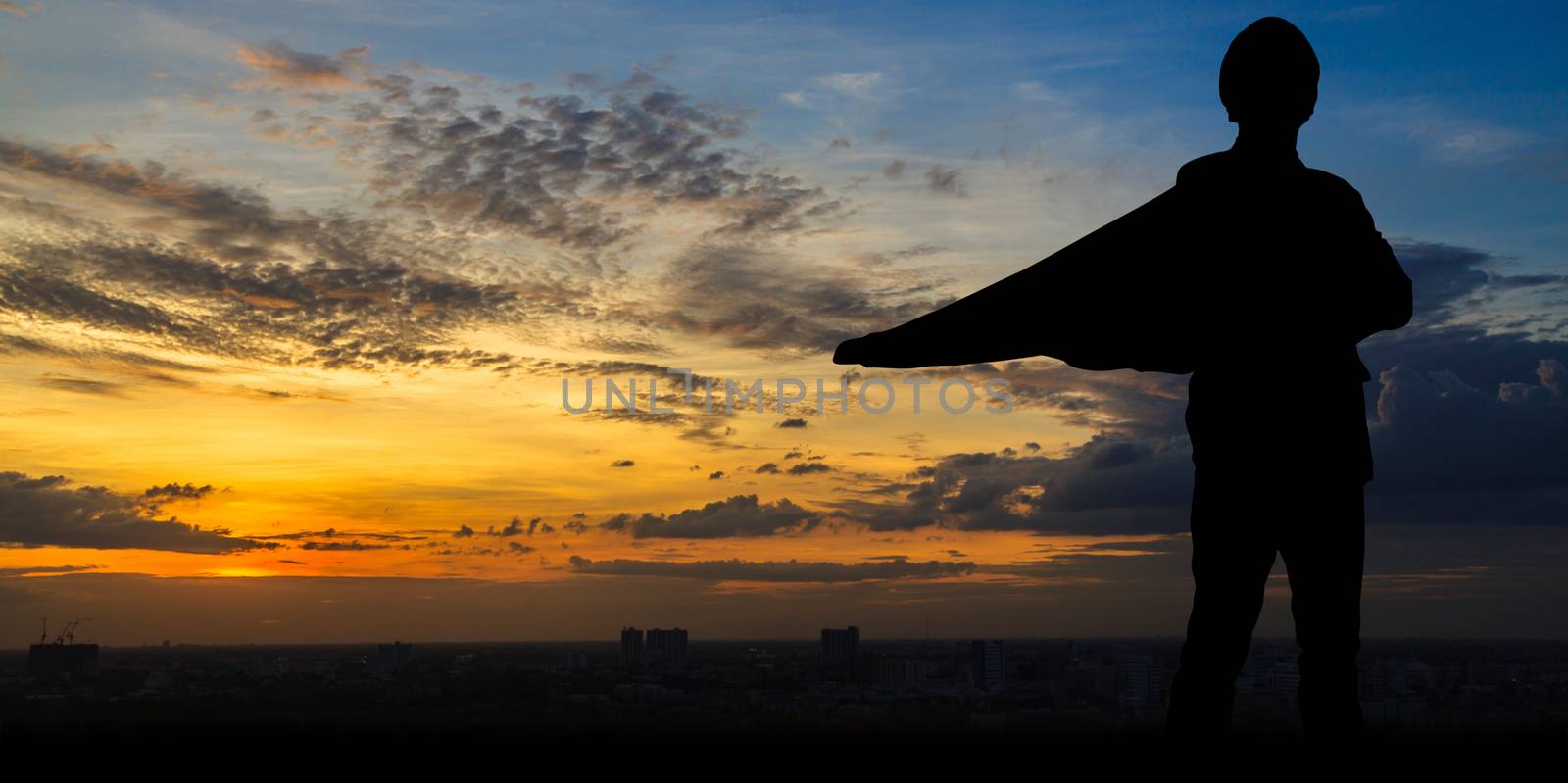 Silhouette of Super businessman at twilight in the city