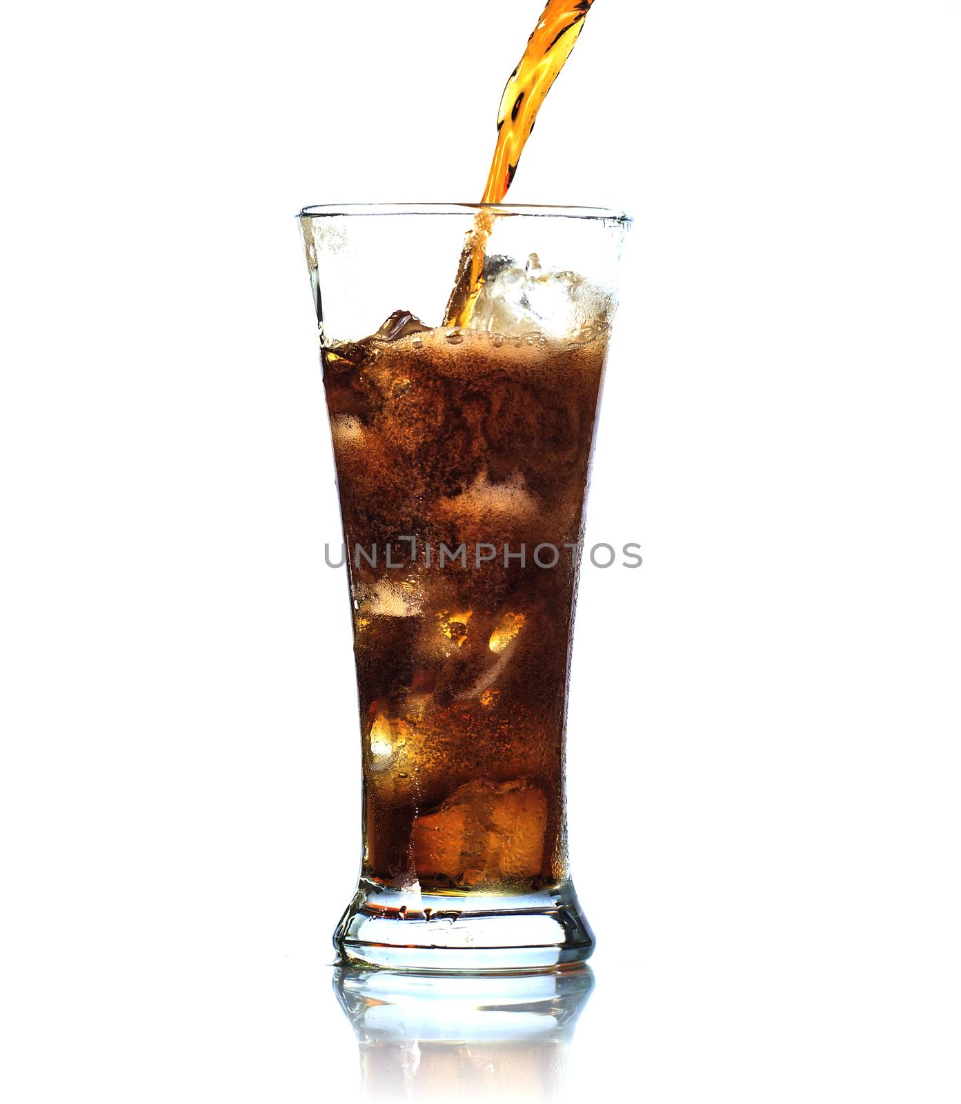 Cola is pouring into glass on white background