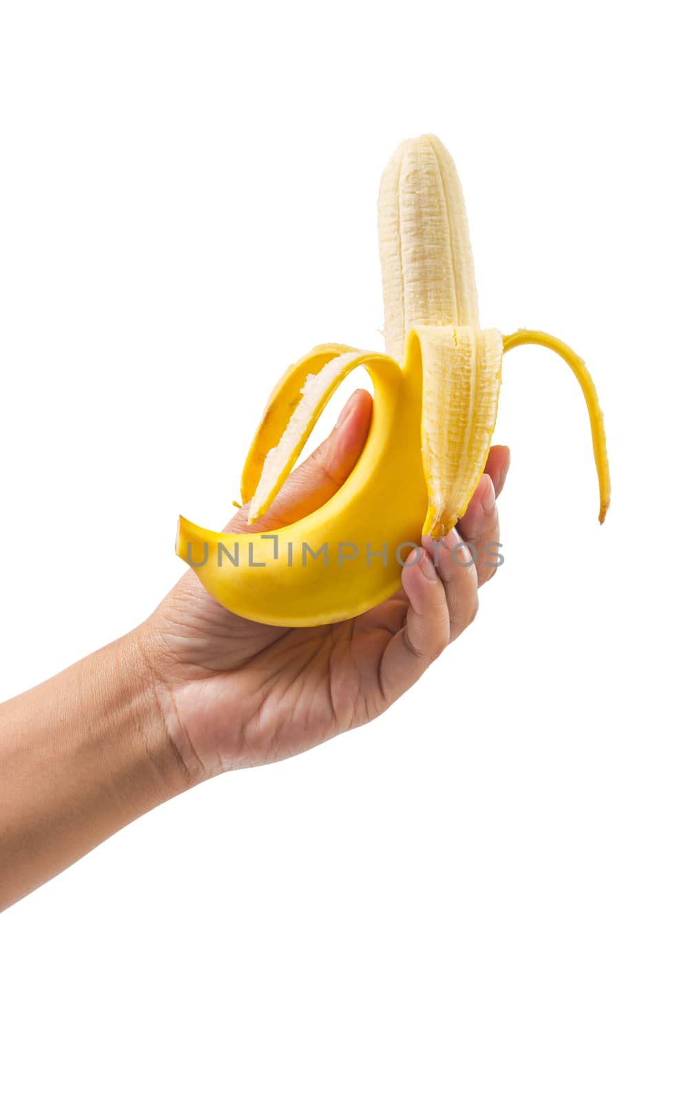 The peeled banana in a female hand. by Gamjai