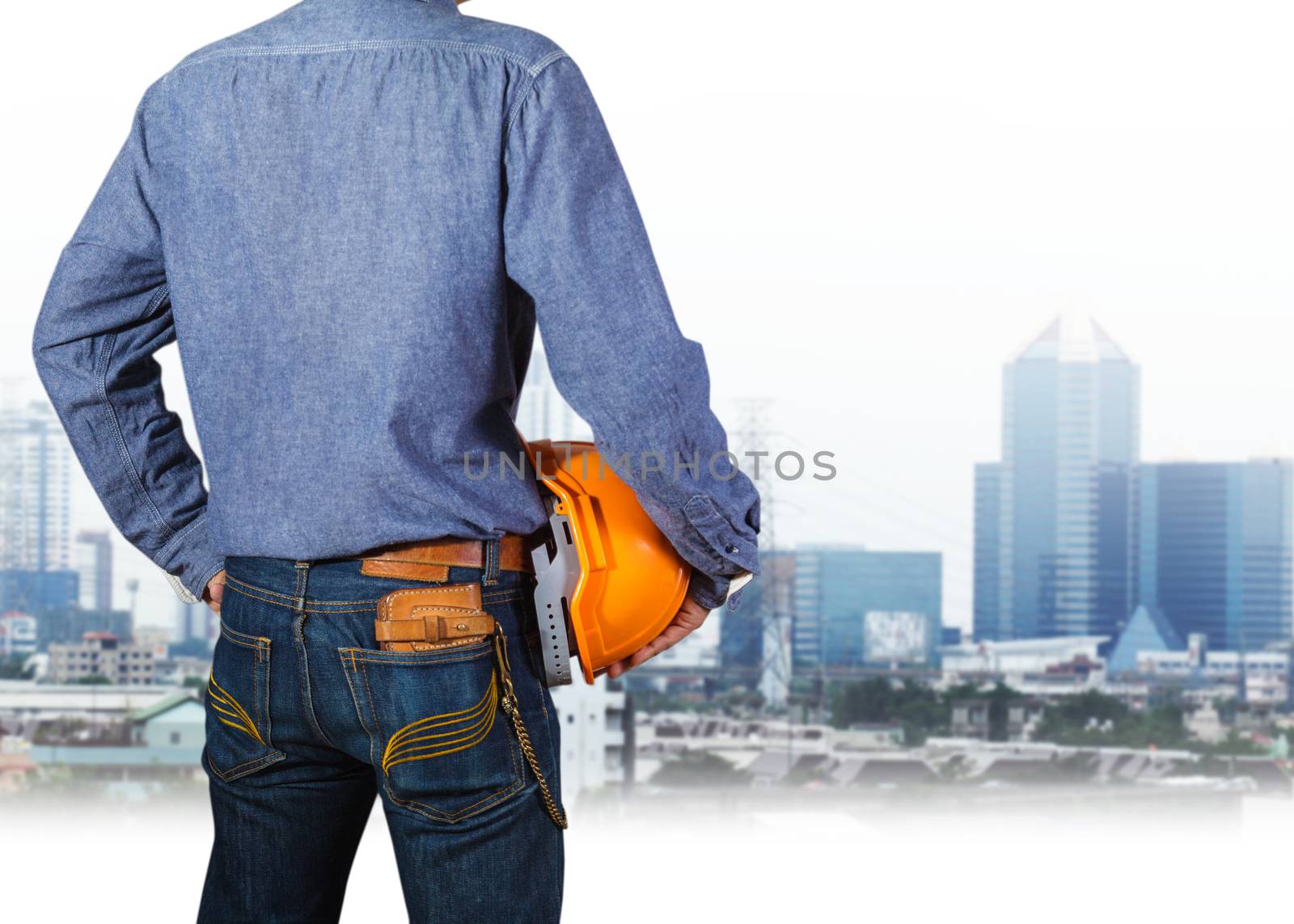 Cropped view of construction worker with orange helmets at workplace on construction site