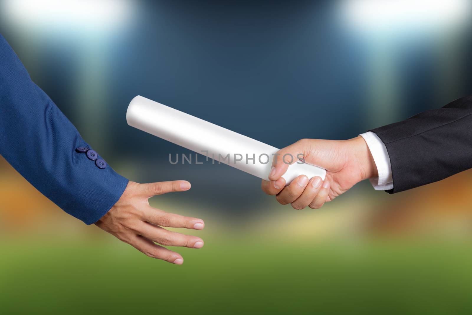 Cropped hand of businessman passing relay baton to colleague, the concept of teamwork for business success