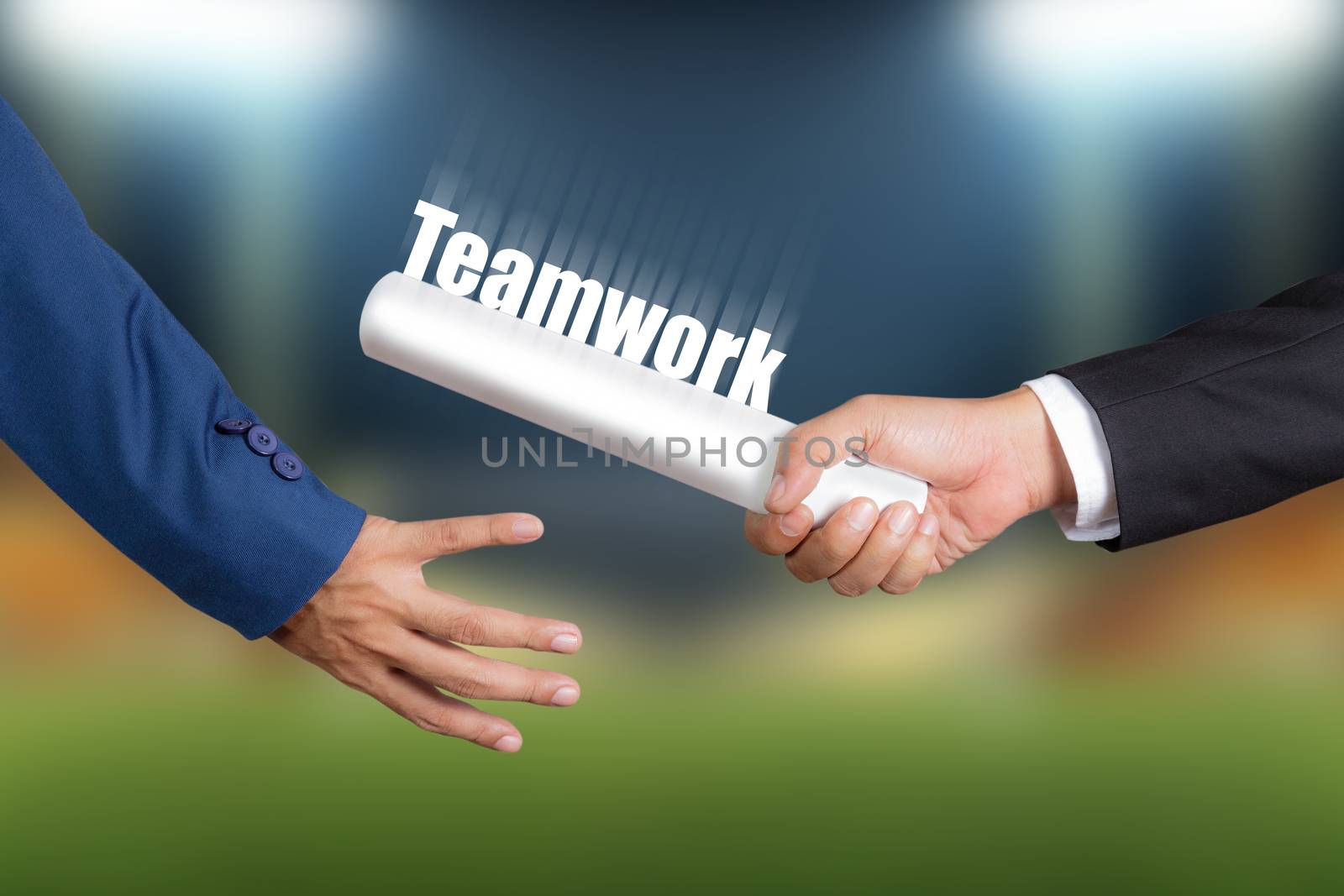 Cropped hand of businessman passing relay baton to colleague, the concept of teamwork for business success