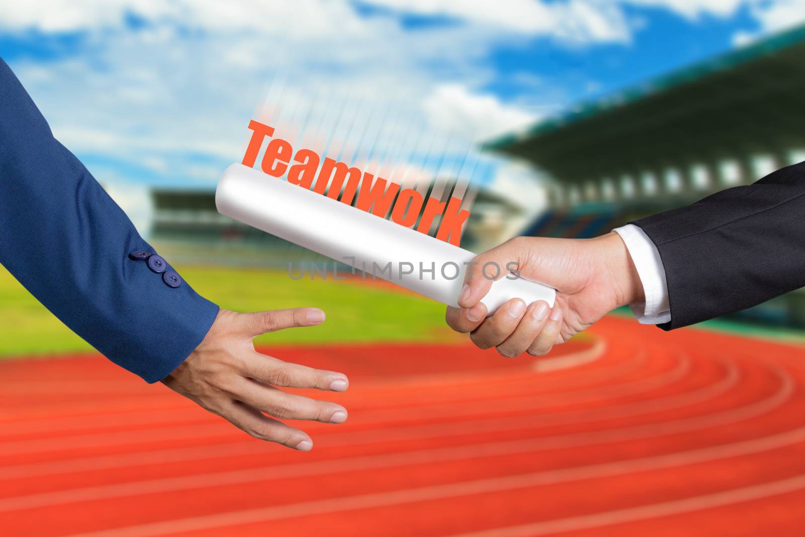 Cropped hand of businessman passing relay baton to colleague, the concept of teamwork for business success