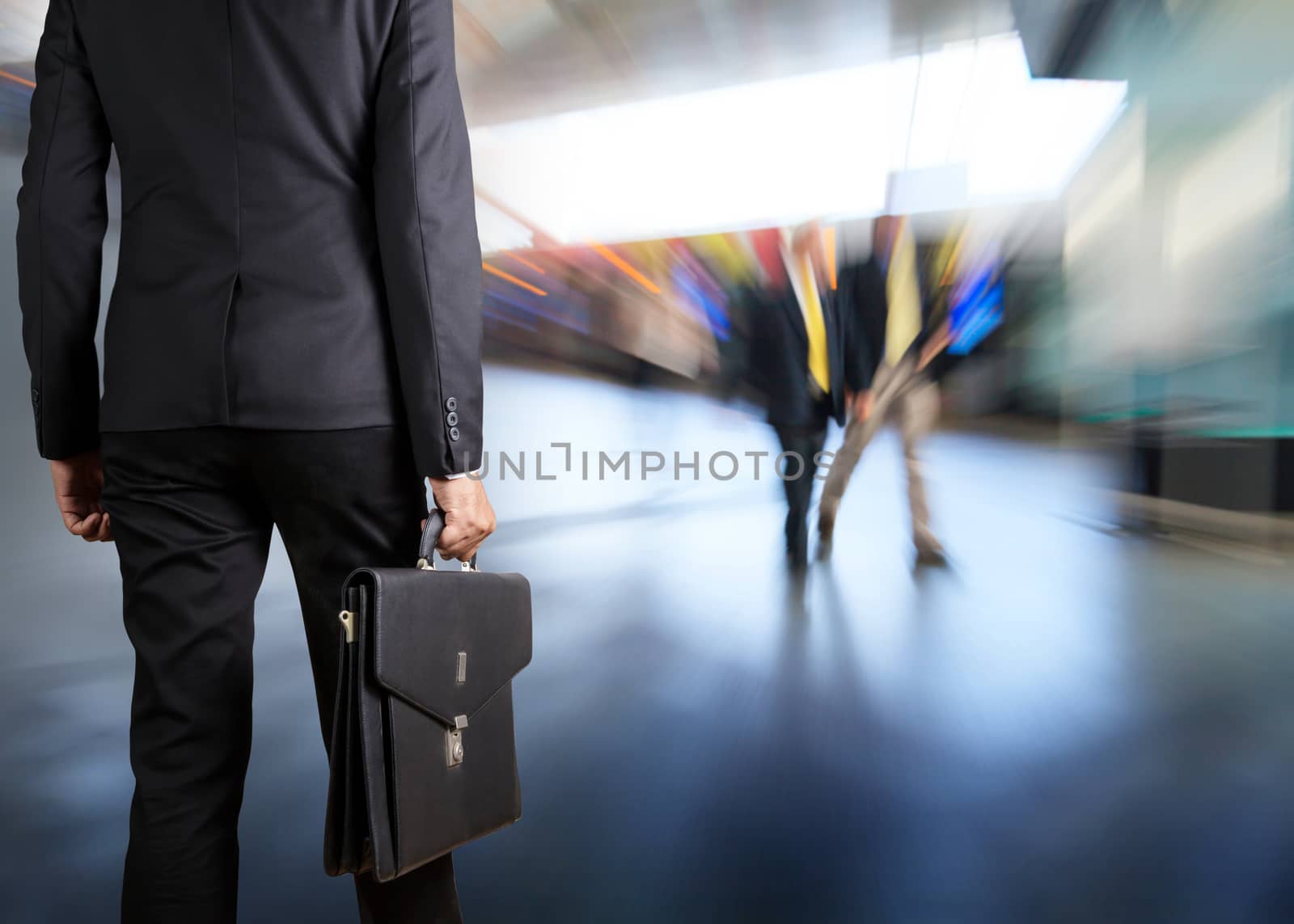 Businessman holding a briefcase in a modern office