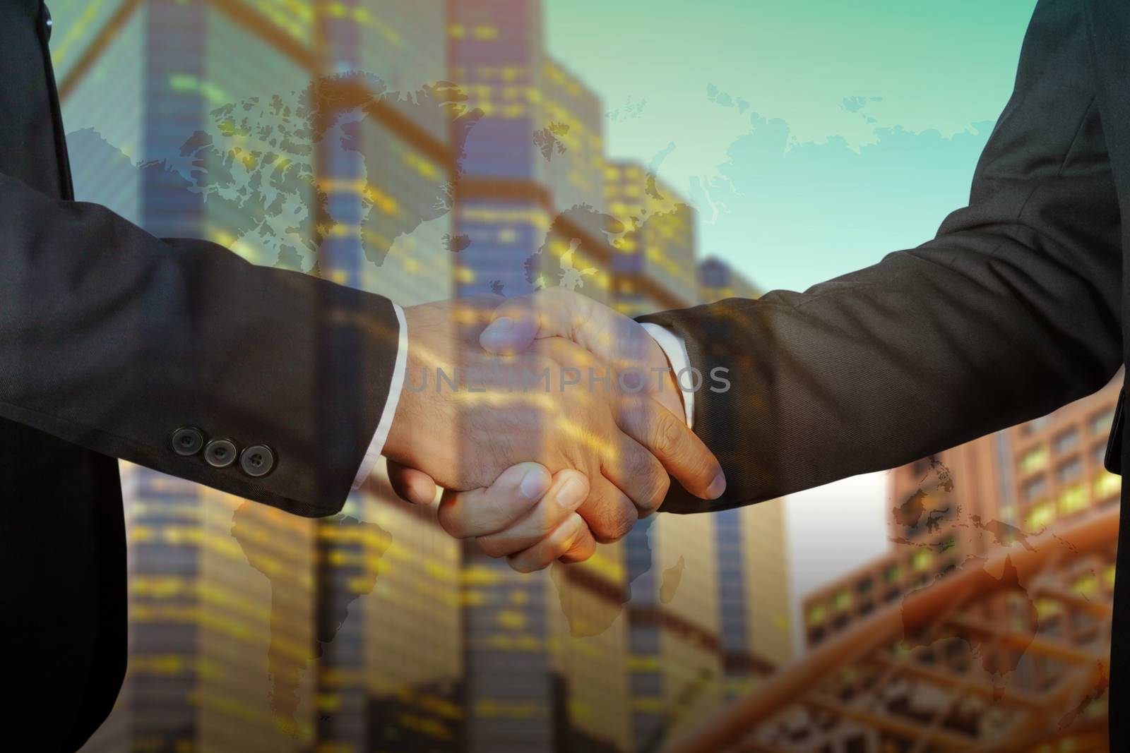 Double exposure of Businessman handshake, Successful businessmen handshaking in a modern office blurred background