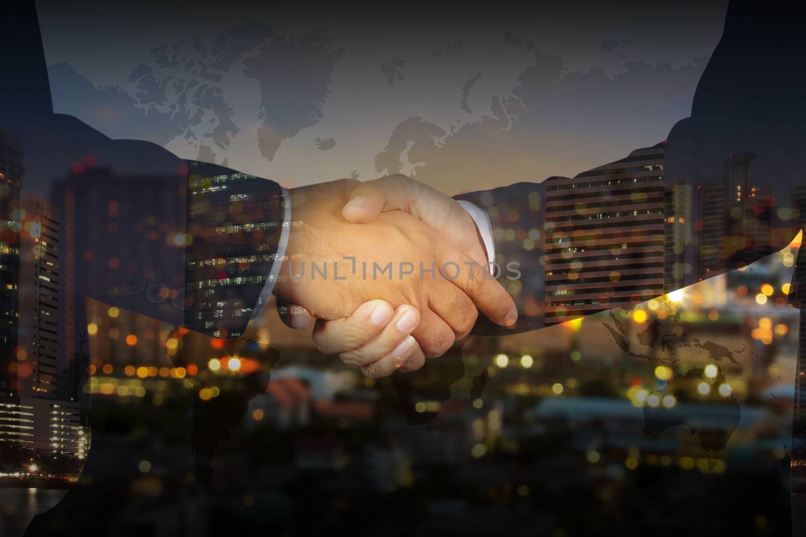 Double exposure of Businessman handshake, Successful businessmen handshaking in a modern office blurred background